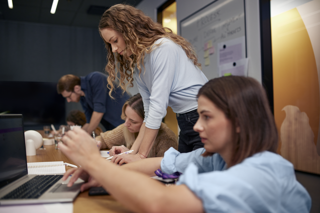 A group of colleagues appear to be in a workshop in an office.