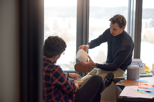 Two people talking in an office.