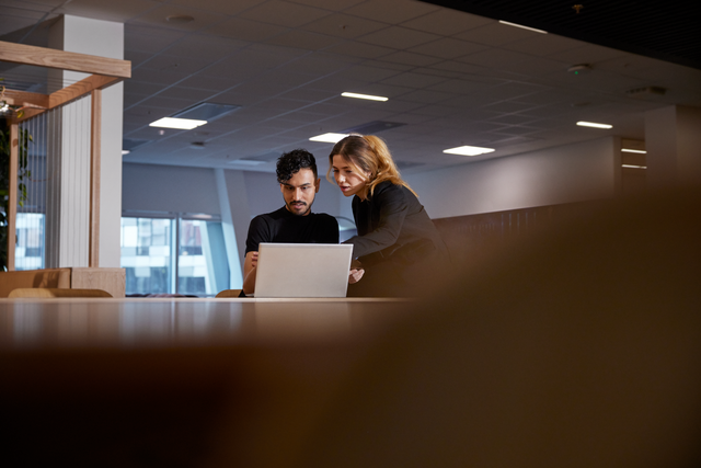 Two people in front of a laptop.